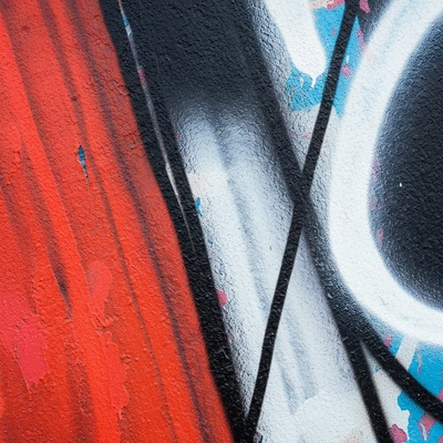 Detailed close-up of a street art mural with subtle Italian cultural motifs